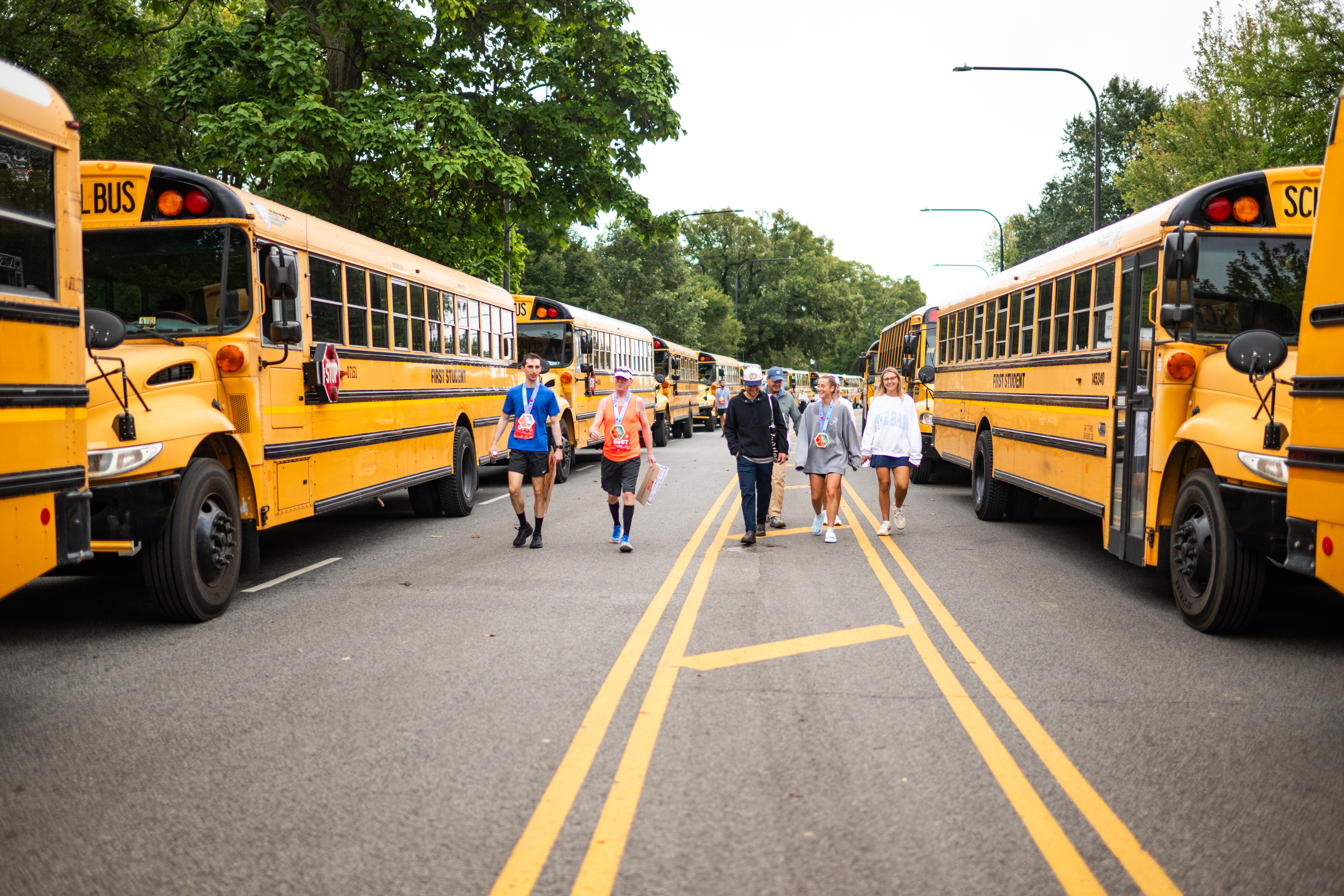 buses parked along the road with event participants